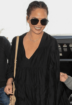 Chrissy Teigen, all smiles as she arrives at LAX airport