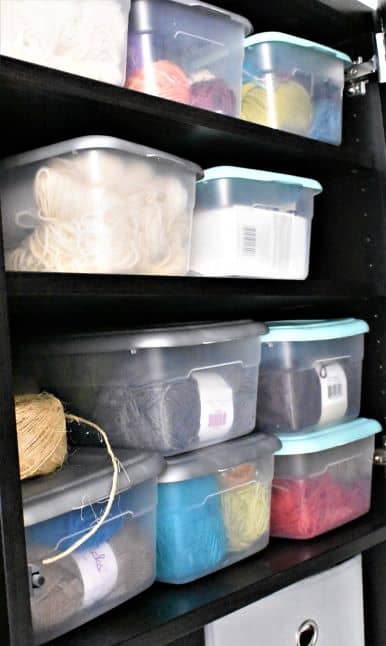 Containers holding yarn in cabinet