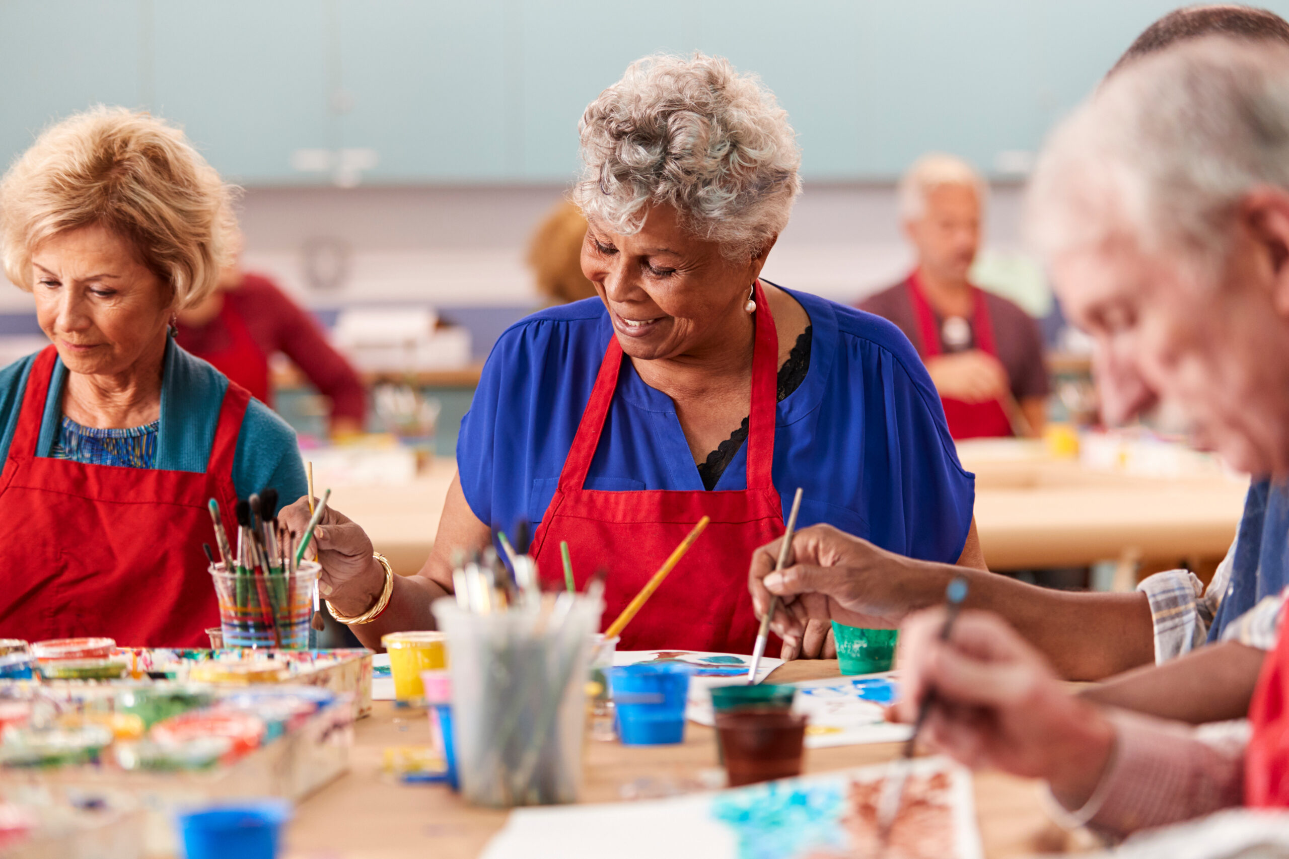 Retired Senior Woman Attending Art Class In Community Centre Retired Senior Woman Attending Art Class In Community Centre