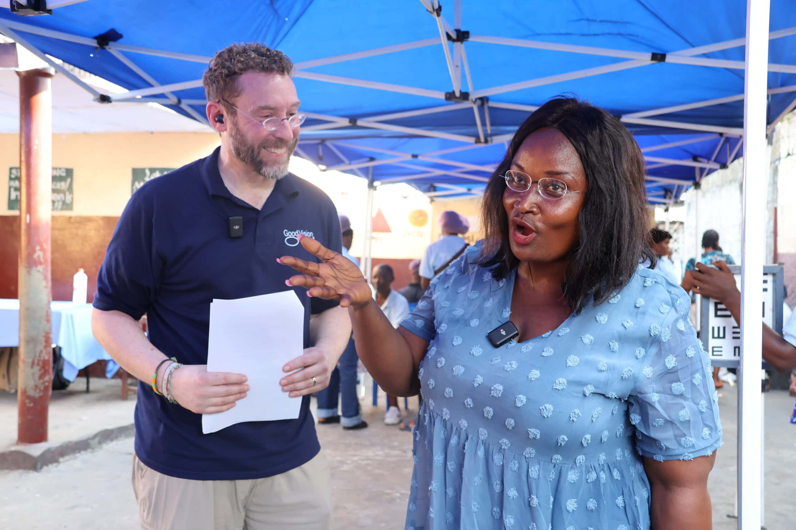 Beneficiary Mercy, pictured with GVUSA Executive Director Matt Gianino, enthusiastically shows off her new GoodVision glasses.