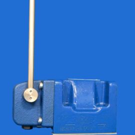 Blue industrial machine with a vertical brass rod and circular adjustment knob on the left.