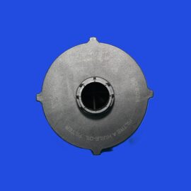 Close-up of a gray metal circular part with a central hole against a bright blue background.