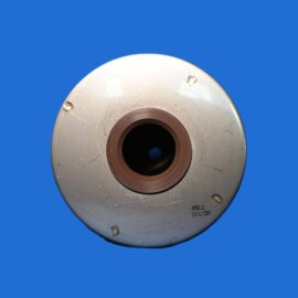 Close-up of a worn metal circular flange with a central bore and brown gasket, set against a solid blue background.