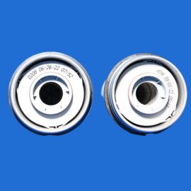 Close-up of two metal stove knobs on a blue background.