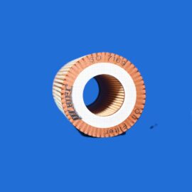 Partial view of a brown textured circular ring with a white perforated center on a blue background.