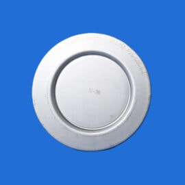 Close-up of a silver metal circular lid with an inner ring, set against a solid blue background.