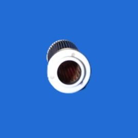 Close-up of a white cylindrical object with a black ridged ring, viewed from below against a solid blue background