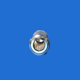 Close-up of a chrome camera lens against a bright blue background, showing the lens opening and ridged exterior.