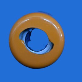 Close-up of an orange donut-shaped ring with a metal inner sleeve against a solid blue background.