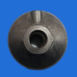 Close-up of a dark metal round component with a central bore and a small top notch against a blue background.