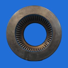Close-up of a circular metal oil filter with pleated inner element against a blue background, viewed from the side.