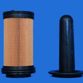Close-up of a pleated brown paper filter cartridge beside a black cylindrical pipe against a blue background.