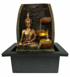 zen water feature with golden buddha statue