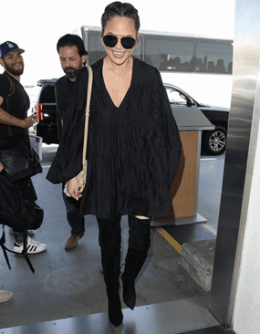 Chrissy Teigen, all smiles as she arrives at LAX airport