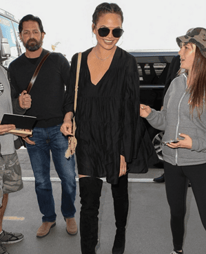 Chrissy Teigen, all smiles as she arrives at LAX airport