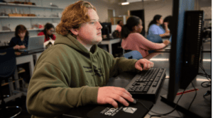 Student typing on computer