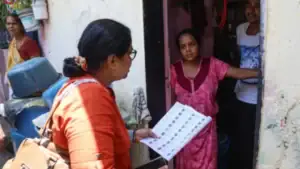 Election officials reviewing voter records and electoral roll documents during the voter verification process in Bengaluru