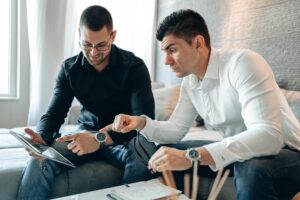 Celebrate Pride Month with These 9 Fabulous Date Night Ideas for the LGBTQIA+ Community 12 man in black long sleeve shirt pointing tablet to man in white long sleeve