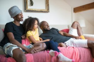 Celebrate Pride Month with These 9 Fabulous Date Night Ideas for the LGBTQIA+ Community 14 a family watching on the living room