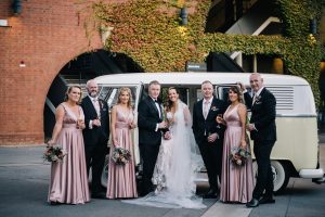 bridal party at Adelaide oval posing in front of VW combi van