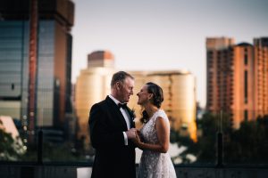 bride and groom together at Adelaide oval with sky city casino in background