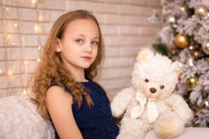 Girl at christmas with teddy bear