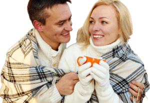 man giving woman coffee on a cold winter day