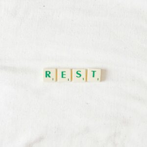 scrabble letters spelling out the word "rest"