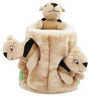 Plush dog toy. Cute brown squirrels in a wood stump.