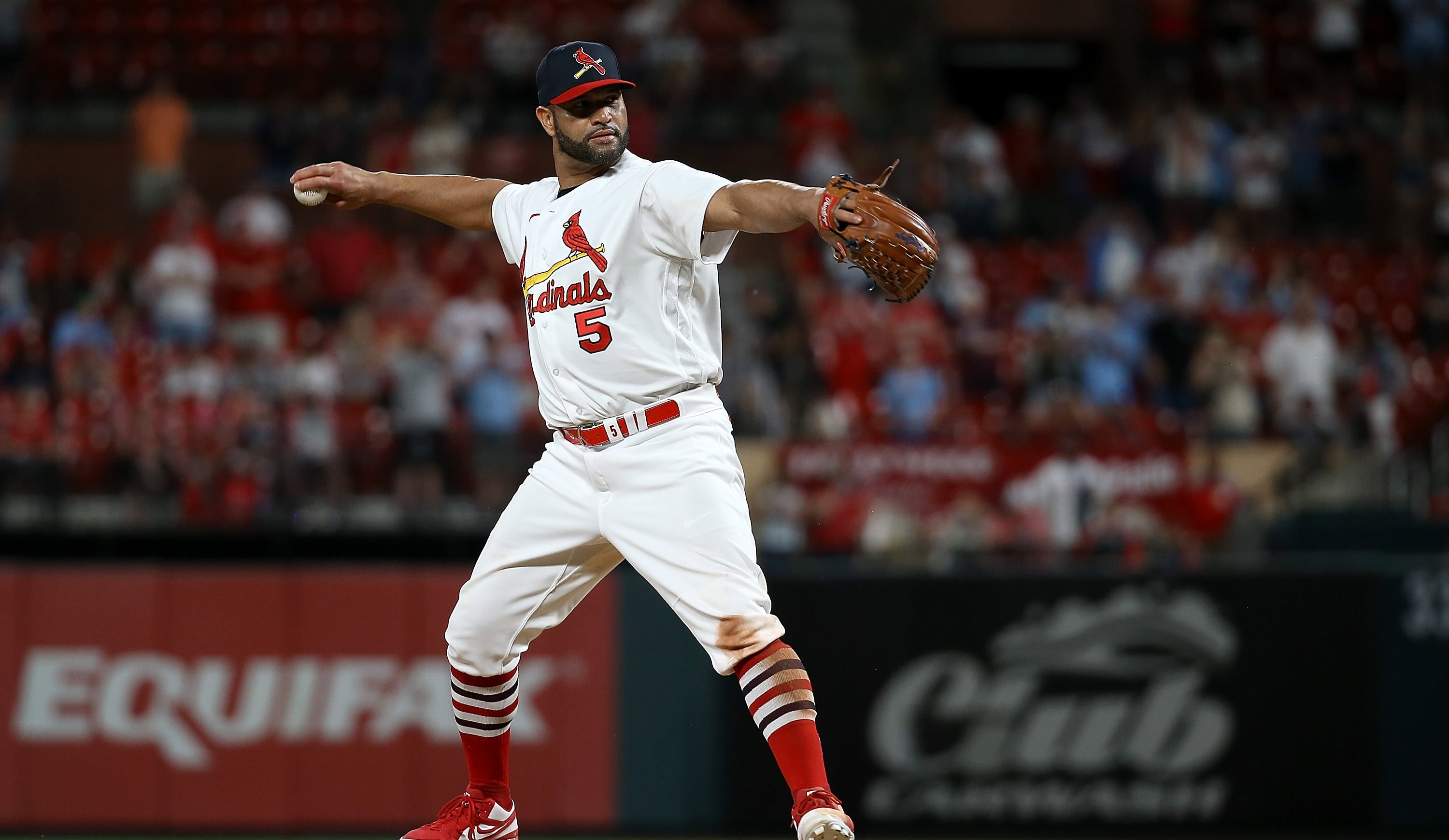 St. Louis Cardinals baseball player Albert Pujols pitching a baseball from the pitcher's mound at Busch Stadium in St. Louis