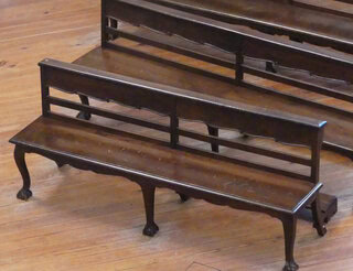 Church bench. Its unique height and lack of cushion makes it a fast-uncomfortable seating.