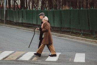 old man and old woman walking down the street