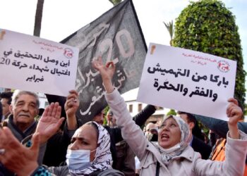 Moroccans raise placards as they gather in front of parliament in the capital Rabat to protest against rising prices, on February 20, 2022. (AFP)