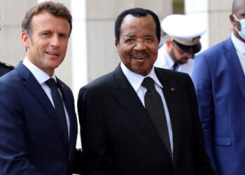 Cameroon's President Paul Biya shakes hands with his French counterpart Emmanuel Macron at the presidencial palace in Yaounde, Cameroon, July 26, 2022. REUTERS/Desire Danga Essigue. NO RESALES. NO ARCHIVES