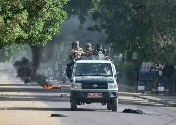 Chad policemen patrol in a vehicle during clashes with opposition demonstrators in N'Djamena on April 27, 2021. - At least five people were killed on April 27, 2021 during protests in Chad against a junta that took power after the death of longserving leader Idriss Deby Itno, prosecutors told AFP. (Photo by Issouf SANOGO / AFP) (Photo by ISSOUF SANOGO/AFP via Getty Images)