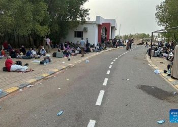 People wait to be evacuated near an airport in Omdurman, Sudan, April 26, 2023. As conflict continues in Sudan, many people have fled to neighboring countries. Xinhua