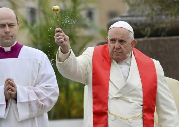 Pope Francis blesses faithful with olive and palm branches before celebrating the Palm Sunday's mass in St. Peter's Square at The Vatican Sunday, April 2, 2023 a day after being discharged from the Agostino Gemelli University Hospital in Rome, where he has been treated for bronchitis, The Vatican said. The Roman Catholic Church enters Holy Week, retracing the story of the crucifixion of Jesus and his resurrection three days later on Easter Sunday. (AP Photo/Filippo Monteforte, pool)