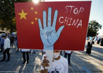 A Uyghur protester holds a sign October 1 during a demonstration in Istanbul, Turkey. (© Emrah Gurel/AP Images)