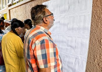 Voters check the electoral roll before at a polling station during the 2024 Mauritian general election at Beau Vallon, in Mahebourg on November 10, 2024.Photo | AFP