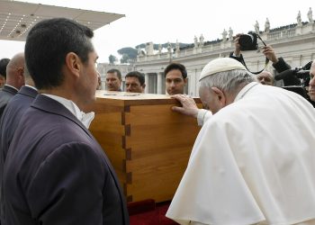 Pope Francis touches the casket of Pope Benedict XVI at the conclusion of his funeral Mass in St. Peter's Square at the Vatican Jan. 5, 2023. (CNS photo/Vatican Media)