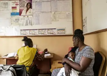 A nurse with patients at a hospital in Kisumu, Kenya, on April 24. Nearly 18 percent of adults in Kisumu have HIV — about four times the national average of 4.5 percent. (Michel Lunanga/Getty Images)