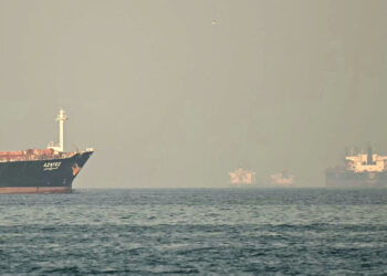 Cargo ships and tankers are seen off coast city of Fujairah, in the Strait of Hormuz in the northern Emirate on February 25, 2026. (Photo by Giuseppe CACACE / AFP)