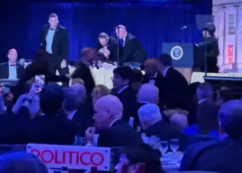 Secret Service agents quickly respond to protect President Donald Trump during the White House Correspondents Dinner, Saturday, April 25, 2026, in Washington. (AP Photo/Mark Schiefelbein)