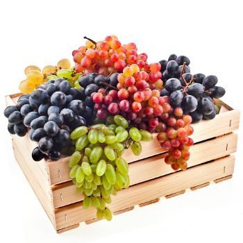 Mixed bunches of grapes in crate on white bg