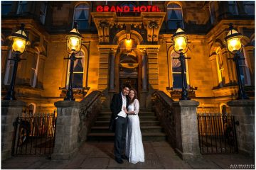 Front of the Grand Hotel in Tynemouth night time bride and groom portrait