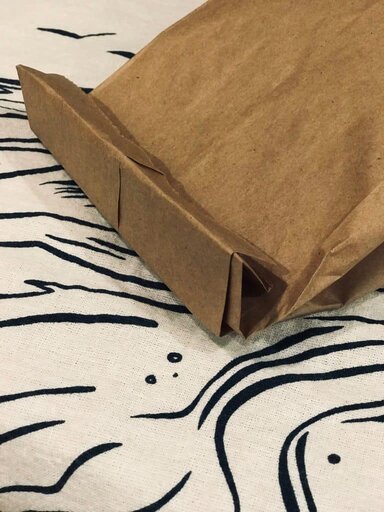 Microwave Popcorn In Paper Bag folded over on towel - Paper bag popcorn