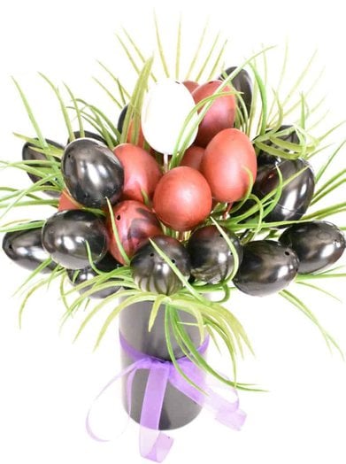 Black, red, and white egg bouquet with palm fronds