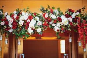 floral decoration in with mini-vases and bouquets of flowers hanging from the ceiling and door arch.