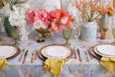 Festive table decor. Many pastel colors. Luxury wedding, party, birthday. Yellow berries. Copper chairs and dishes, gold and silver cutlery. Chinese, European, chinoiserie style. Peonies and roses.