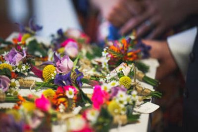 Closeup of boutonnieres on a white table